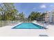 Inviting community pool featuring lounge chairs and well maintained landscaping at 850 S Tamiami Trl # 431, Sarasota, FL 34236