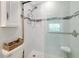 This remodeled shower includes glass doors, marble tile, and bench seat at 850 S Tamiami Trl # 431, Sarasota, FL 34236