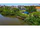 Beautiful waterfront community featuring lush greenery, a tranquil pond, and a private dock at 850 S Tamiami Trl # 431, Sarasota, FL 34236