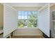A bright window featuring white shutters and a view of mature landscaping at 850 S Tamiami Trl # 431, Sarasota, FL 34236
