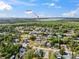 Residential aerial view showcasing neighborhood homes near the ocean surrounded by lush trees at 8622 Inwood Dr, Hudson, FL 34667