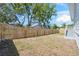Spacious backyard featuring a new wood fence, stairs to the house, and a lush green lawn at 8622 Inwood Dr, Hudson, FL 34667