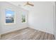 Bright bedroom with two windows and wood-look flooring at 8622 Inwood Dr, Hudson, FL 34667