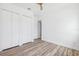 Bright bedroom with wood-look flooring and closet at 8622 Inwood Dr, Hudson, FL 34667