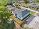 Aerial view of a well-maintained home with a gray roof and wood fence surrounded by greenery at 8622 Inwood Dr, Hudson, FL 34667