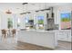 Modern, airy kitchen with a large island, stainless steel appliances, stone backsplash, and a casual dining area at 8622 Inwood Dr, Hudson, FL 34667