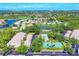 Beautiful aerial view of the community featuring lush landscaping, a pool, and a tennis court at 8931 Veranda Way # 415, Sarasota, FL 34238
