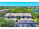 Exterior view showcases condos with private balconies, garages, and ample parking in a well-maintained community at 8931 Veranda Way # 415, Sarasota, FL 34238