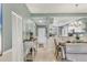 Inviting hallway leads to a bright kitchen and dining area, with ample storage and stylish decor at 8931 Veranda Way # 415, Sarasota, FL 34238