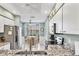 Modern kitchen with stainless steel appliances, granite countertops, and an adjacent breakfast table area at 8931 Veranda Way # 415, Sarasota, FL 34238