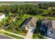 Aerial view of the home showcasing its pristine landscaping and surrounding lush greenery and lakes at 10171 Milky Way Cir, Sarasota, FL 34241