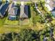 An aerial view showing the home's backyard, the surrounding landscaping, and neighborhood walkways at 10171 Milky Way Cir, Sarasota, FL 34241