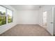 Bright bedroom with neutral carpet and a large window allowing natural light at 10171 Milky Way Cir, Sarasota, FL 34241