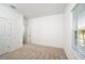 This bedroom features neutral carpet, a window and white walls for a calm and inviting space at 10171 Milky Way Cir, Sarasota, FL 34241
