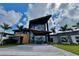 Beautiful modern clubhouse featuring large glass windows, a striking entrance, and meticulously kept landscaping at 10171 Milky Way Cir, Sarasota, FL 34241