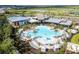 Resort-style community pool featuring lounge chairs, palm trees, and a modern recreational center at 10171 Milky Way Cir, Sarasota, FL 34241