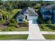 Beautiful home exterior featuring a well manicured lawn, a long driveway, and ample landscaping at 10171 Milky Way Cir, Sarasota, FL 34241