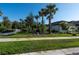 Home exterior featuring lush landscaping, a sidewalk, and vibrant green grass at 10171 Milky Way Cir, Sarasota, FL 34241