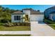 Charming one-story home featuring a well-manicured lawn and a two-car garage with lovely landscaping at 10171 Milky Way Cir, Sarasota, FL 34241