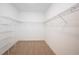 This walk-in closet offers wall-mounted metal shelving and carpet flooring at 10171 Milky Way Cir, Sarasota, FL 34241