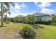 Expansive backyard featuring lush lawn, screened lanai, and tropical landscaping at 11508 Griffith Park Ter, Bradenton, FL 34211