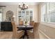 Bright breakfast nook with plantation shutters, chandelier, and wicker chairs surrounding a wooden table, illuminated by natural light at 11508 Griffith Park Ter, Bradenton, FL 34211