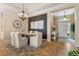 Elegant dining room features a rustic wood table, stylish chandelier, and sophisticated neutral decor, creating a warm atmosphere at 11508 Griffith Park Ter, Bradenton, FL 34211