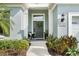 Charming home front door with sidelights, a decorative wreath, and manicured landscaping at 11508 Griffith Park Ter, Bradenton, FL 34211
