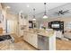 Modern kitchen island with stainless steel dishwasher flowing into the spacious living room at 11508 Griffith Park Ter, Bradenton, FL 34211