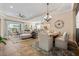 Spacious open-concept living area flows from the living room to the dining area, featuring modern furnishings and neutral tones at 11508 Griffith Park Ter, Bradenton, FL 34211