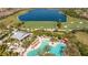 Aerial view of resort-style pool near a golf course and lake at Esplanade Golf and Country Club at 12619 Sorrento Way, Bradenton, FL 34211