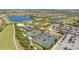 Aerial view showcasing tennis courts, a pool, and the beautiful community at 12619 Sorrento Way, Bradenton, FL 34211