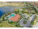 Aerial view of the community clubhouse, pool, and tennis courts at 12619 Sorrento Way, Bradenton, FL 34211