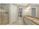 Bright bathroom featuring a glass shower, granite countertops, and access to the primary bedroom at 12619 Sorrento Way, Bradenton, FL 34211