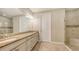 Well-lit bathroom with double sinks, granite countertops, and a glass shower at 12619 Sorrento Way, Bradenton, FL 34211