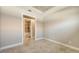 An empty bedroom with tile floors and view of the bathroom via doorway at 12619 Sorrento Way, Bradenton, FL 34211
