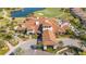 Aerial view of clubhouse with tile roof and manicured landscaping at Esplanade Golf and Country Club at 12619 Sorrento Way, Bradenton, FL 34211