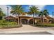 Beautiful clubhouse exterior with lush landscaping and brick paver entry at 12619 Sorrento Way, Bradenton, FL 34211