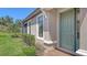 Charming home with a green front door, complemented by manicured landscaping and a brick walkway at 12619 Sorrento Way, Bradenton, FL 34211