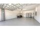 Spacious garage featuring a golf cart, shelving, a sealed floor, and ample storage at 12619 Sorrento Way, Bradenton, FL 34211