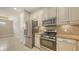 Modern kitchen featuring stainless steel appliances and stone countertops at 12619 Sorrento Way, Bradenton, FL 34211
