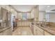 Well-lit kitchen with stainless appliances, stone backsplash, and ample counter space at 12619 Sorrento Way, Bradenton, FL 34211