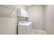 A clean laundry room with modern washer and dryer, white cabinets, and wire shelving at 12619 Sorrento Way, Bradenton, FL 34211