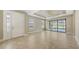 Bright living room with tile floors, a tray ceiling, and sliding glass doors leading to the outdoor patio at 12619 Sorrento Way, Bradenton, FL 34211