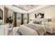 Nicely staged bedroom with bed, blinds, curtains, and decor at 12619 Sorrento Way, Bradenton, FL 34211