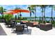 Outdoor patio with tables, chairs, couches, and a view of a lake at 12619 Sorrento Way, Bradenton, FL 34211