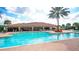 Community pool with a covered patio and plenty of lounge chairs at 12619 Sorrento Way, Bradenton, FL 34211