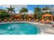 Inviting community pool area showcasing lounge chairs, cabanas, and clear blue water surrounded by tropical landscaping at 12619 Sorrento Way, Bradenton, FL 34211