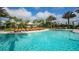 Resort style pool with plenty of lounge chairs and palm trees for relaxing by the pool at 12619 Sorrento Way, Bradenton, FL 34211