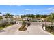 Community entrance with a gatehouse, leading to amenities including a pool and clubhouse at 15172 Cuzcorro Ct, Nokomis, FL 34275